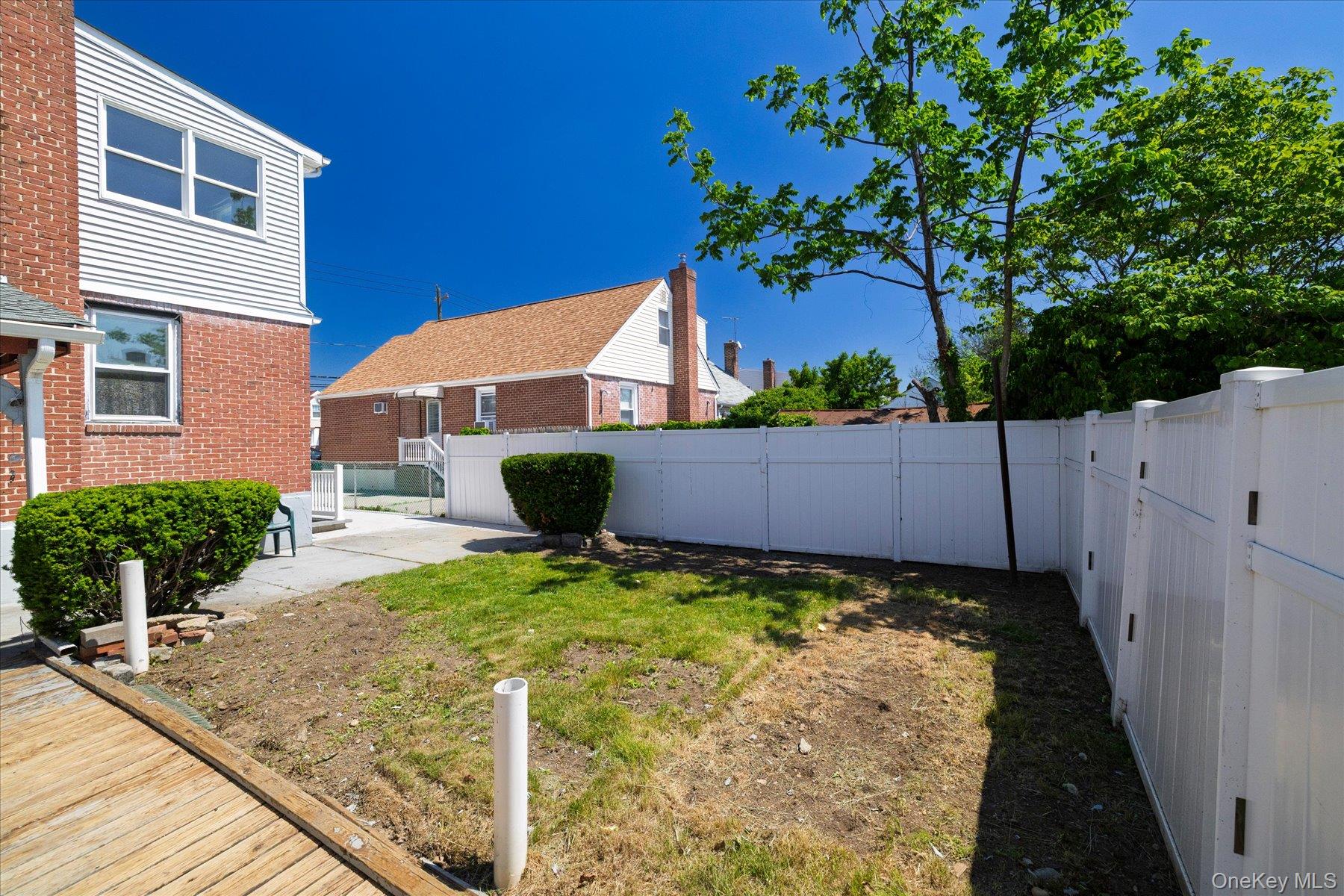 191 Raff Avenue Mineola, NY 11501 - Photo 7 of 25 a view of a house with backyard and sitting area