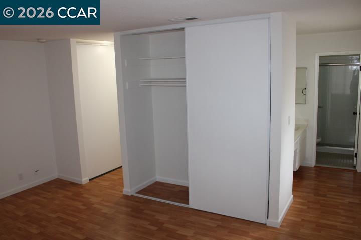 2152 Blue Jay Circle Pinole, CA 94564 - Photo 20 of 31 a view of an empty room with wooden floor