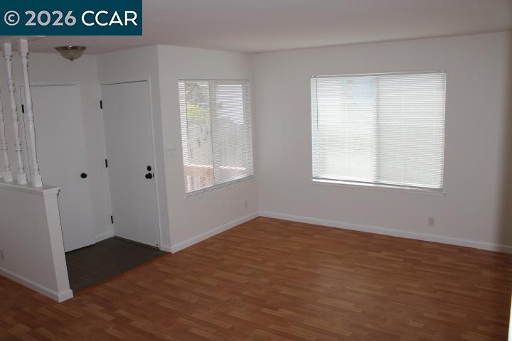 2152 Blue Jay Circle Pinole, CA 94564 - Photo 3 of 31 an empty room with wooden floor and windows