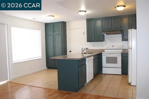 a kitchen with a stove sink and a refrigerator