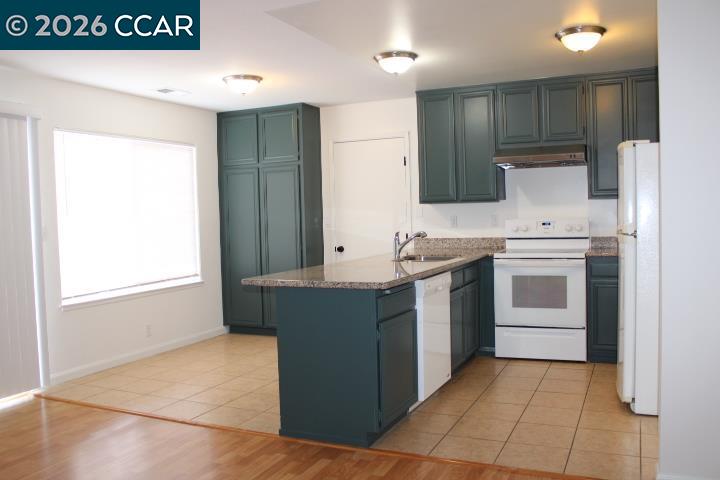2152 Blue Jay Circle Pinole, CA 94564 - Photo 7 of 31 a kitchen with a stove sink and a refrigerator
