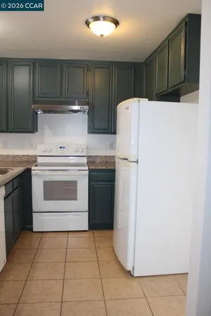 a kitchen with a stove sink and refrigerator