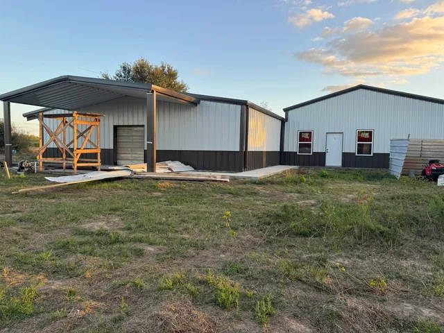 a backyard of a house with table and chairs