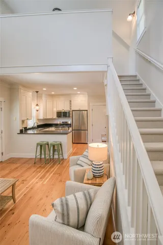 a living room with furniture and kitchen view