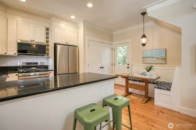 a kitchen with stainless steel appliances kitchen island granite countertop a sink and cabinets