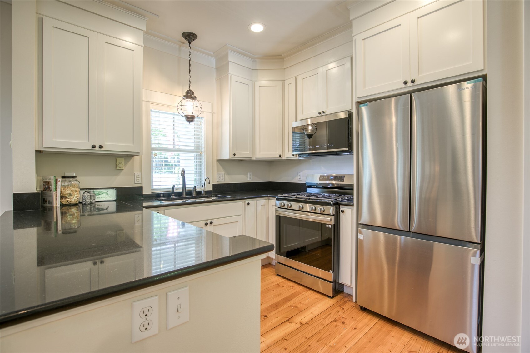 191 Compass Street Pacific Beach, WA 98571 - Photo 7 of 36 a kitchen with stainless steel appliances granite countertop a refrigerator a sink and white cabinets