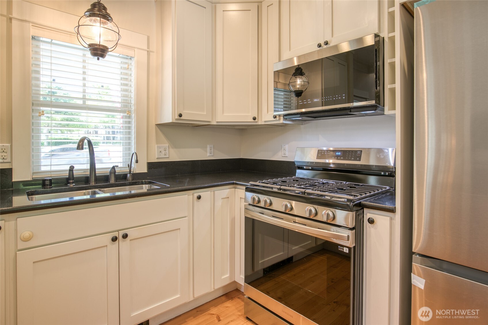 191 Compass Street Pacific Beach, WA 98571 - Photo 8 of 36 a kitchen with stainless steel appliances granite countertop white cabinets and a stove