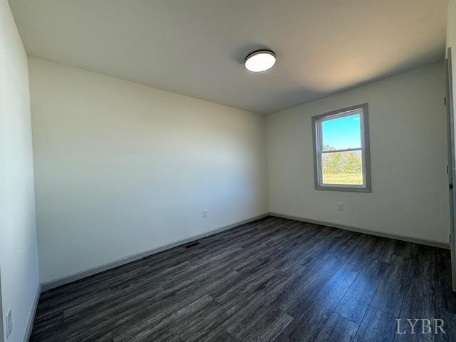2211 Spg Grv Road Spout Spring, VA 24593 - Photo 16 of 24 a view of an empty room with wooden floor and a window