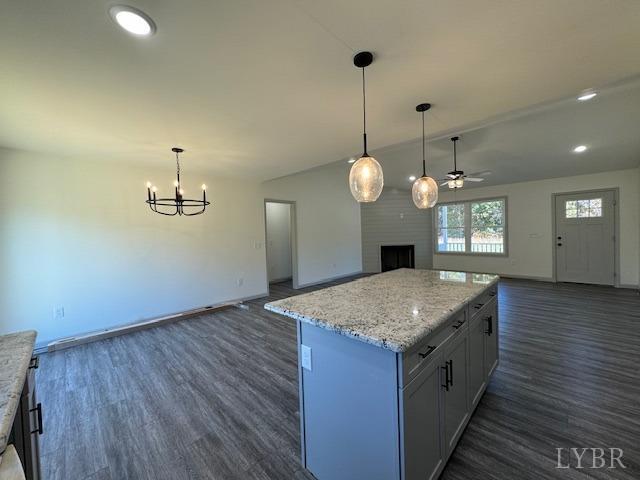 2211 Spg Grv Road Spout Spring, VA 24593 - Photo 8 of 24 a kitchen with a wooden floor and a chandelier