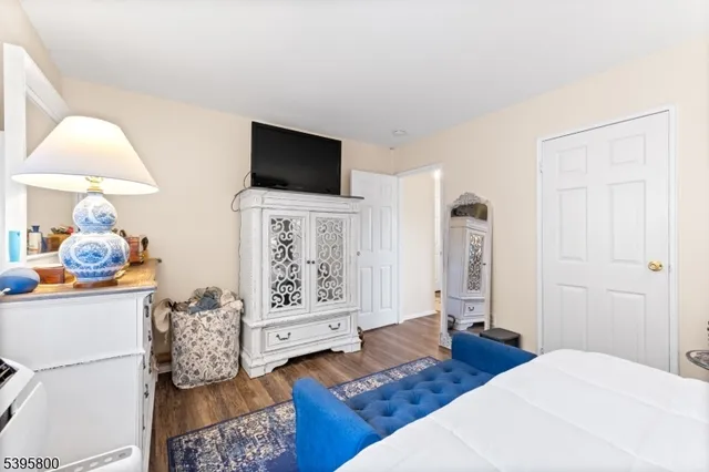 a bedroom with furniture and flat screen tv