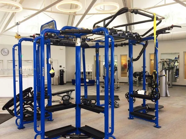 a room with gym equipment and floor to ceiling window
