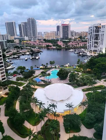 an aerial view of residential houses with outdoor space and lake view
