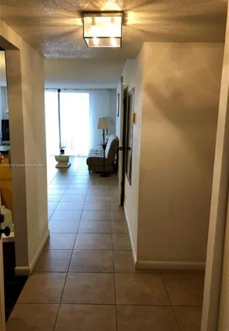 a view of utility room and bedroom with windows