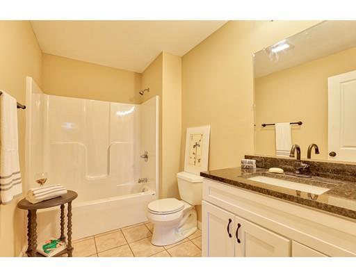 12 Woodland Road Springfield, MA 01129 - Photo 13 of 18 a bathroom with a granite countertop sink toilet a mirror and shower