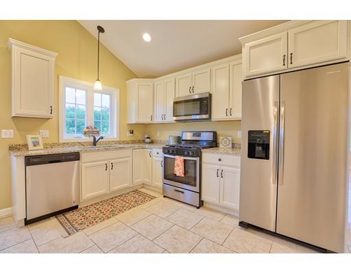12 Woodland Road Springfield, MA 01129 - Photo 2 of 18 a kitchen with white cabinets and white appliances