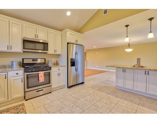 12 Woodland Road Springfield, MA 01129 - Photo 5 of 18 a kitchen with stainless steel appliances kitchen island granite countertop a stove a sink and a refrigerator