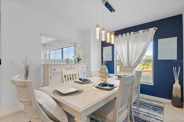 a living room with furniture and a view of kitchen