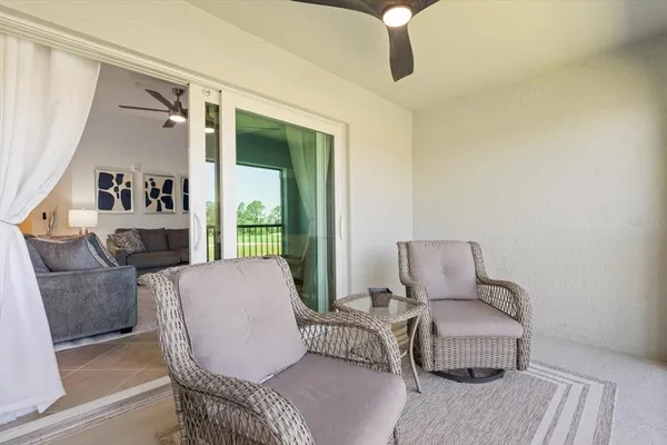 a aerial view of a house with yard porch and furniture