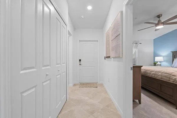 a large white kitchen with stainless steel appliances and a sink