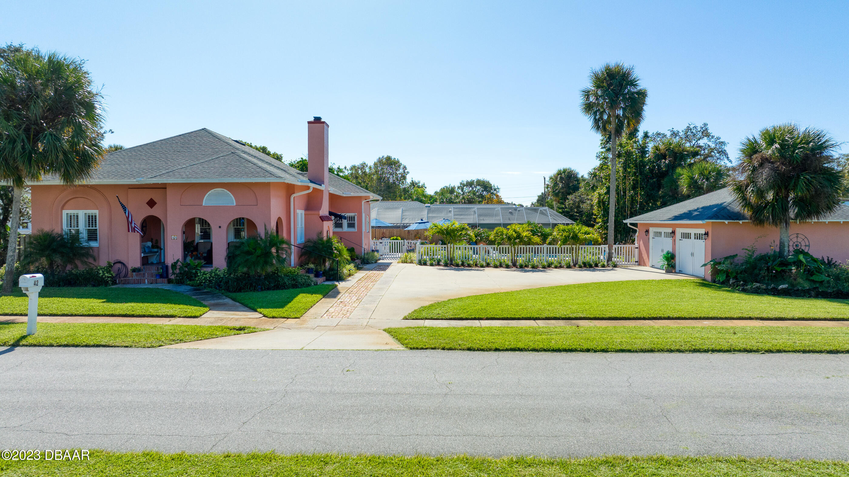 42 River Beach Drive Ormond Beach, FL 32176 - Photo 2 of 74 a front view of a house with a yard and garage