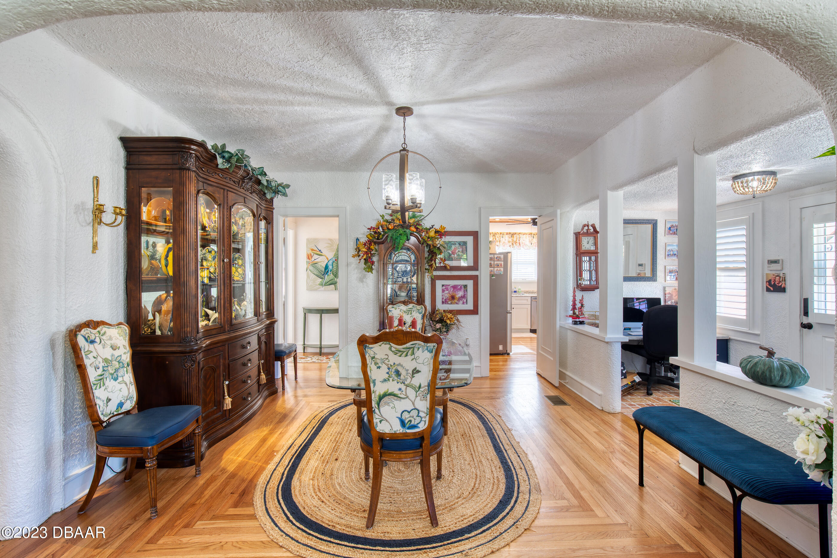 42 River Beach Drive Ormond Beach, FL 32176 - Photo 21 of 74 a living room with furniture a dining table and a chandelier