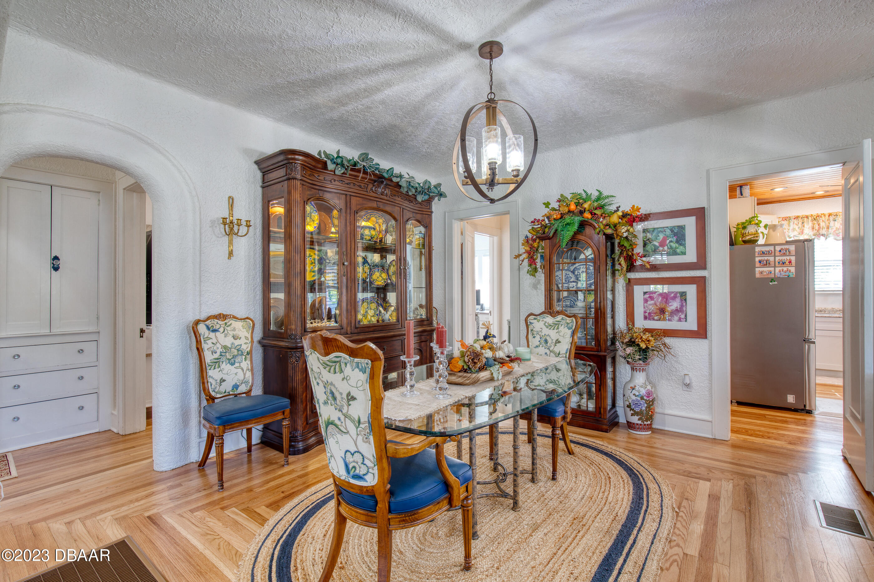42 River Beach Drive Ormond Beach, FL 32176 - Photo 22 of 74 a view of a dining room with furniture wooden floor and chandelier
