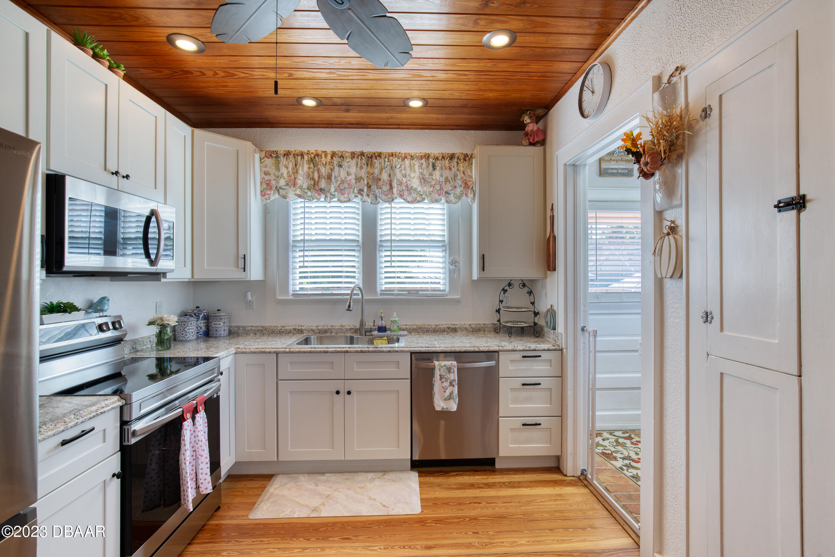 42 River Beach Drive Ormond Beach, FL 32176 - Photo 30 of 74 a kitchen with stainless steel appliances granite countertop a sink stove and refrigerator