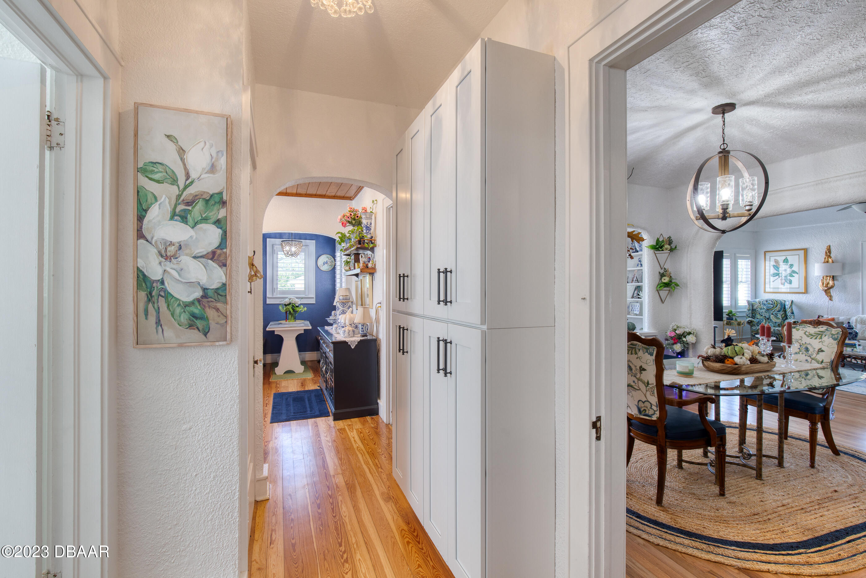 42 River Beach Drive Ormond Beach, FL 32176 - Photo 35 of 74 a view of a dining room with furniture a chandelier and wooden floor