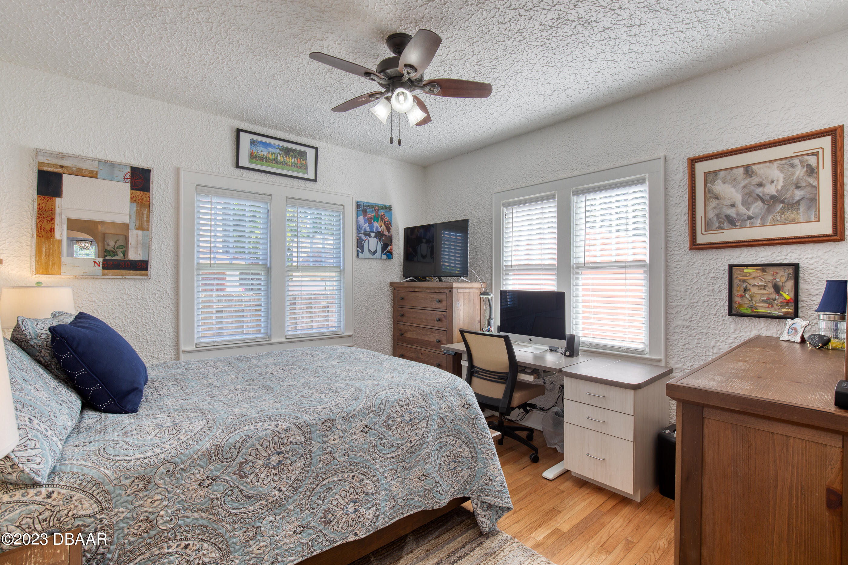 42 River Beach Drive Ormond Beach, FL 32176 - Photo 39 of 74 a bedroom with a large bed and a desk