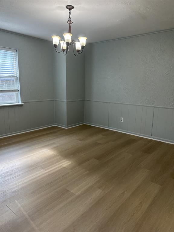 3417 Blue Ridge Lane Garland, TX 75042 - Photo 7 of 9 a view of a room with wooden floor and chandelier
