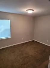 an empty room with a empty space and windows