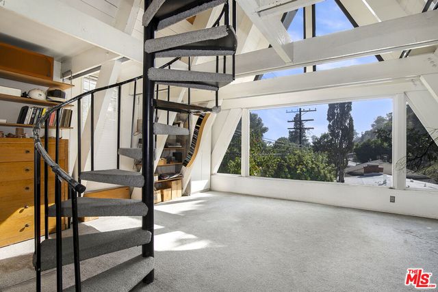 a view of an empty room with windows