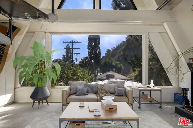 a view of a patio with table and chairs potted plants with wooden floor