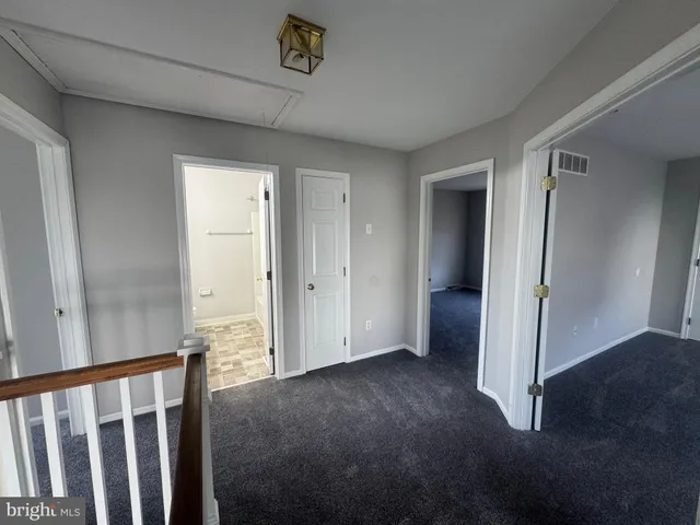 a bathroom with a granite countertop sink a toilet and a mirror