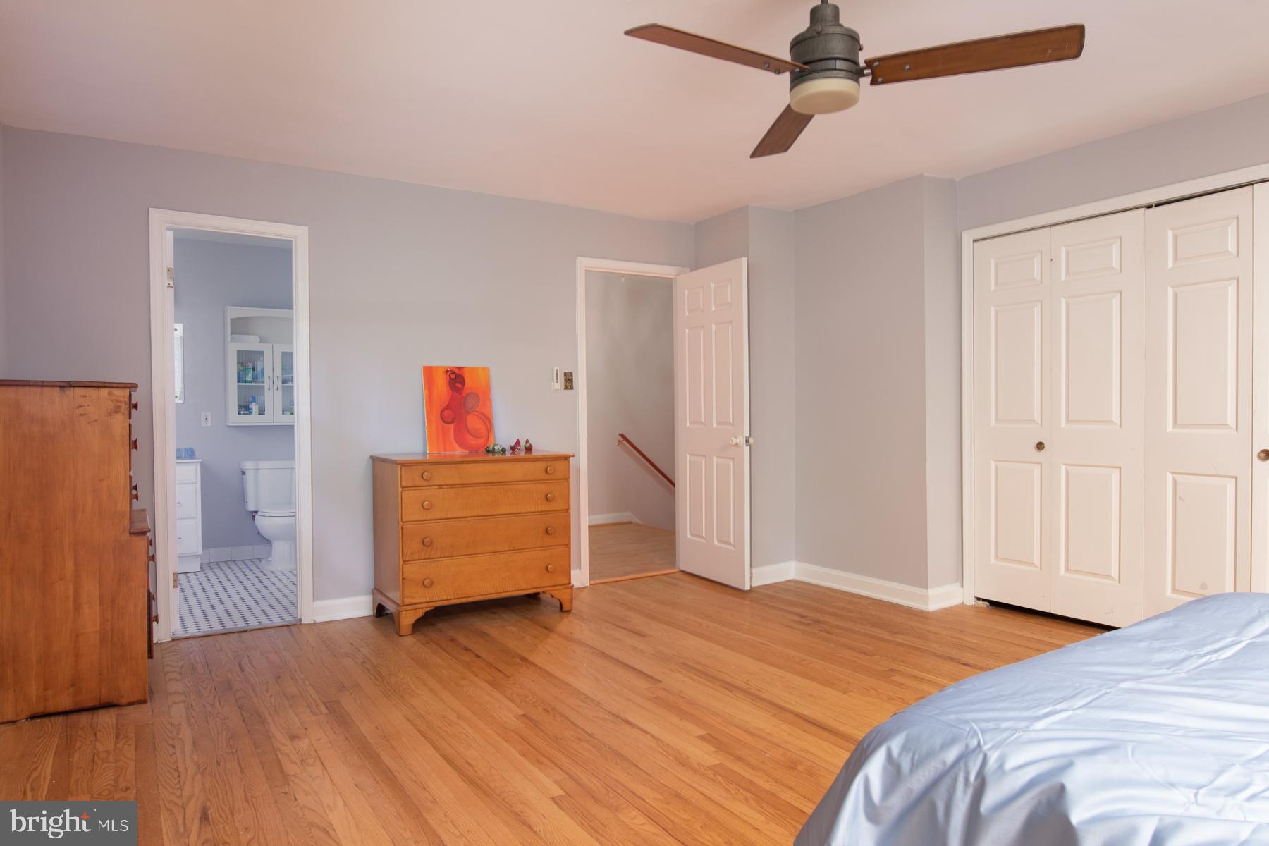 8603 Bradford Road, Unit 105 Silver Spring, MD 20901 - Photo 16 of 36 a bedroom with a bed and wooden floor