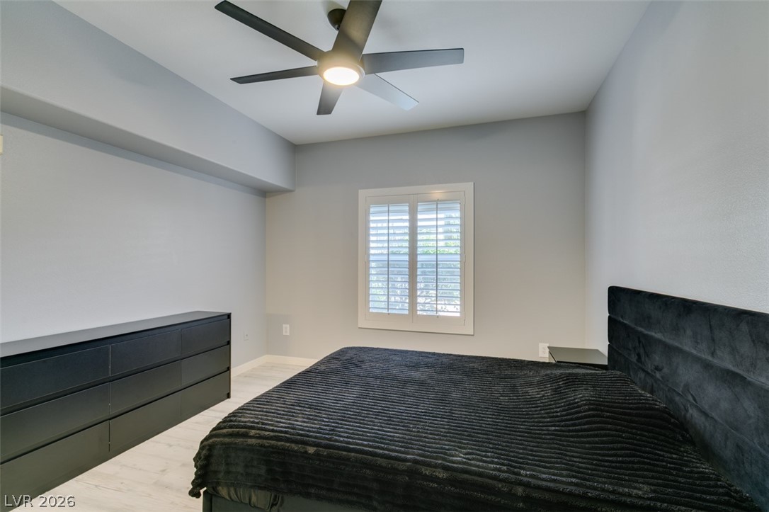7255 West Sunset Road, Unit 1103 Las Vegas, NV 89113 - Photo 32 of 35 A quiet bedroom featuring elegant window shutters and a functional ceiling fan for comfort.