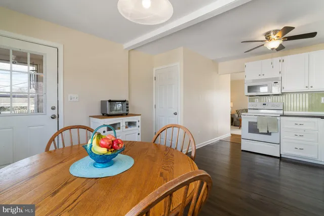 a kitchen with furniture wooden floor and a window