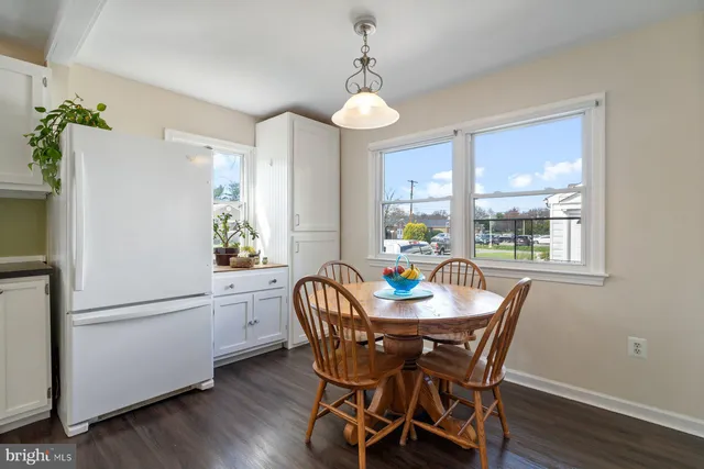 a dining room with furniture a chandelier and wooden floor
