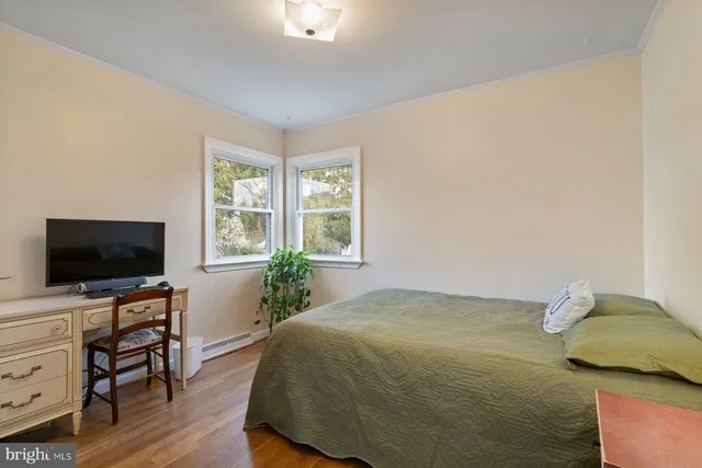 a bedroom with a bed and flat screen tv