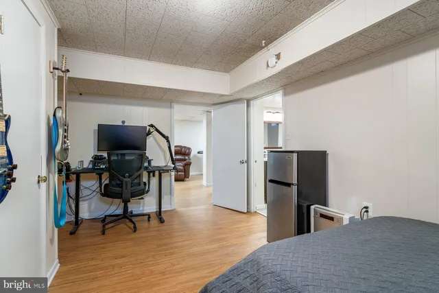 a view of a workspace with furniture and wooden floor