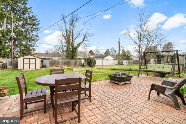 a view of a patio with couches table and chairs and a fire pit