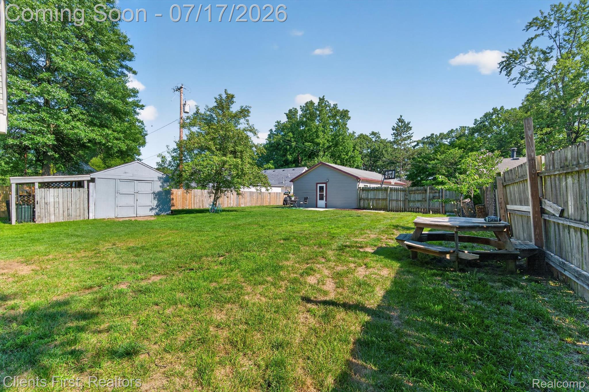 36852 Chase Street Romulus, MI 48174 - Photo 34 of 40 Expansive grassy backyard featuring a detached accessory structure, privacy fencing, and mature trees