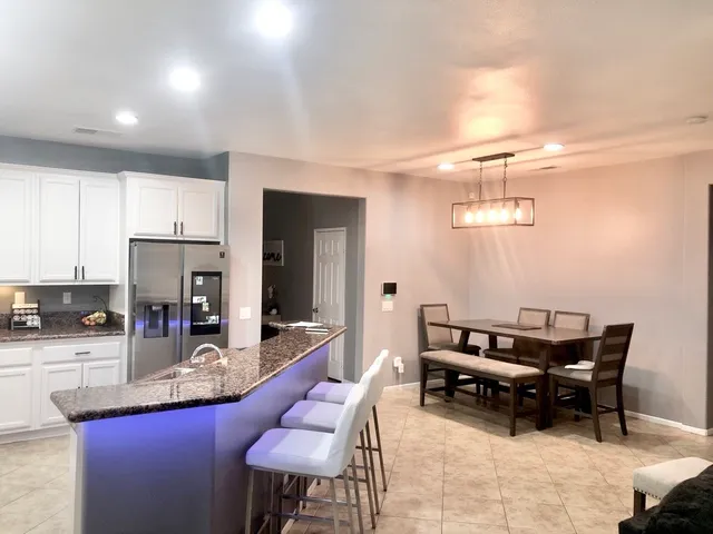 a living room with stainless steel appliances kitchen island granite countertop furniture and a kitchen view