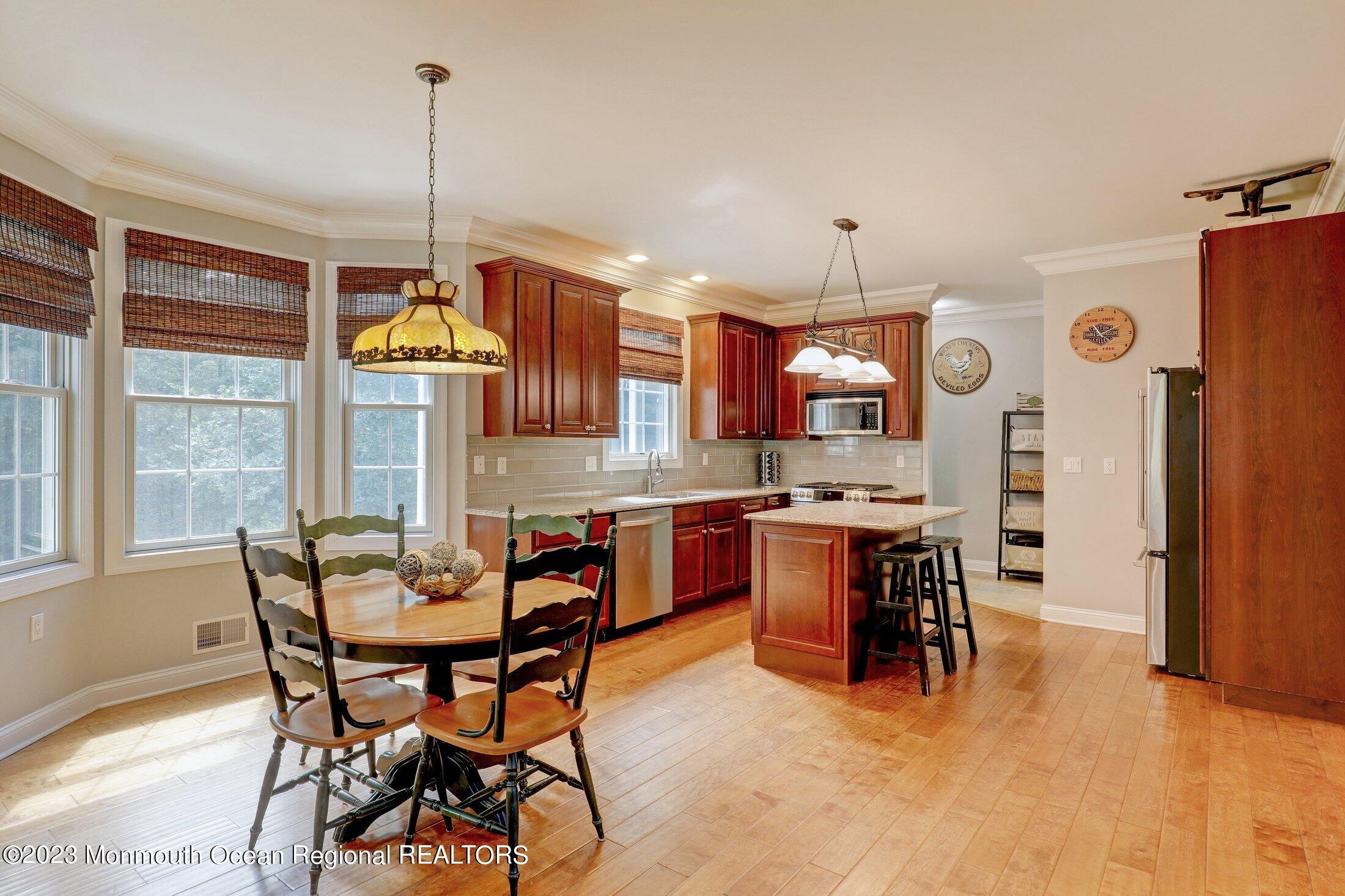 352 Lanes Pond Road Howell, NJ 07731 - Photo 14 of 67 a view of a dining room with furniture window and wooden floor