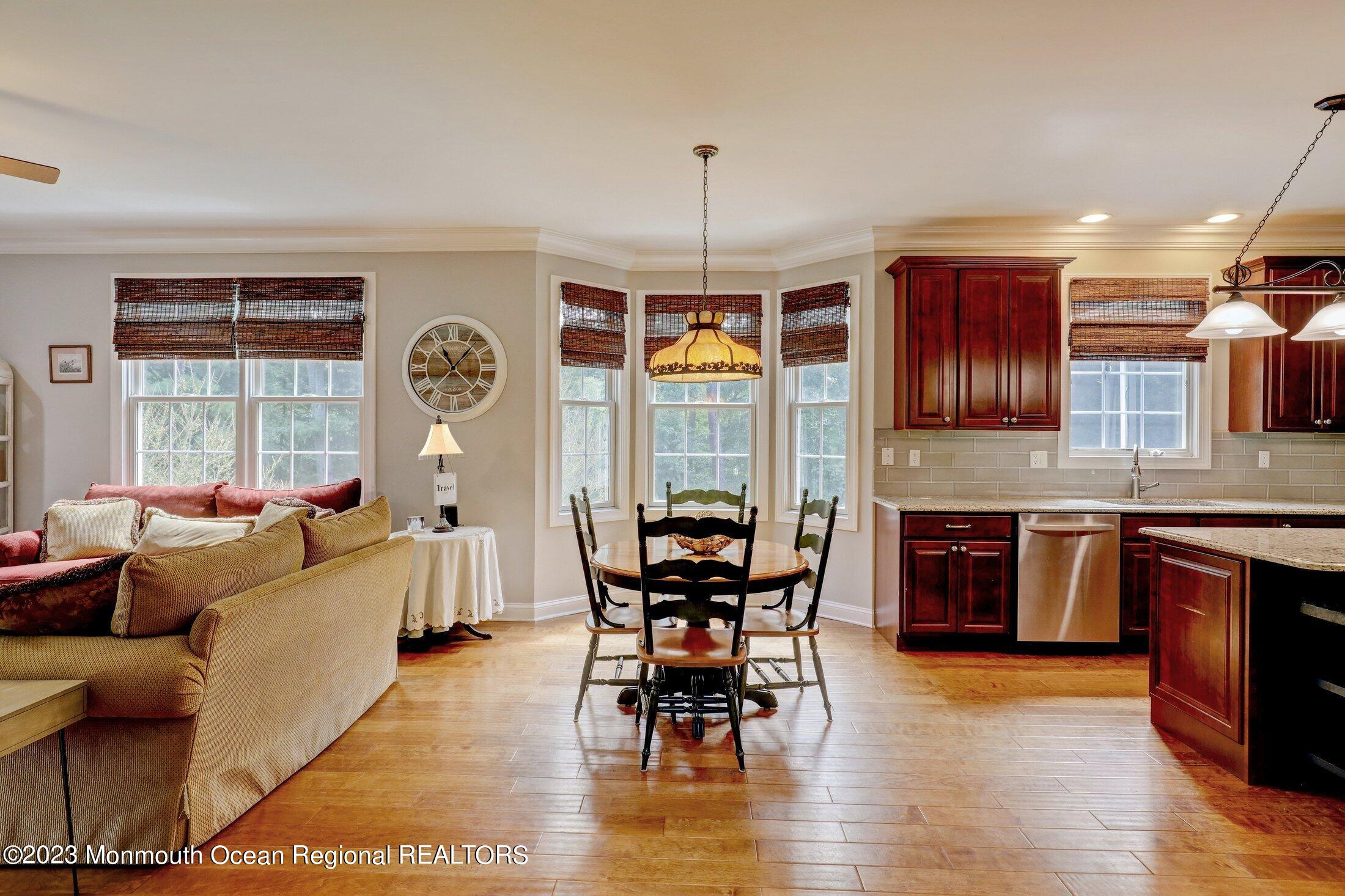 352 Lanes Pond Road Howell, NJ 07731 - Photo 18 of 67 a living room with furniture a dining table and a large window