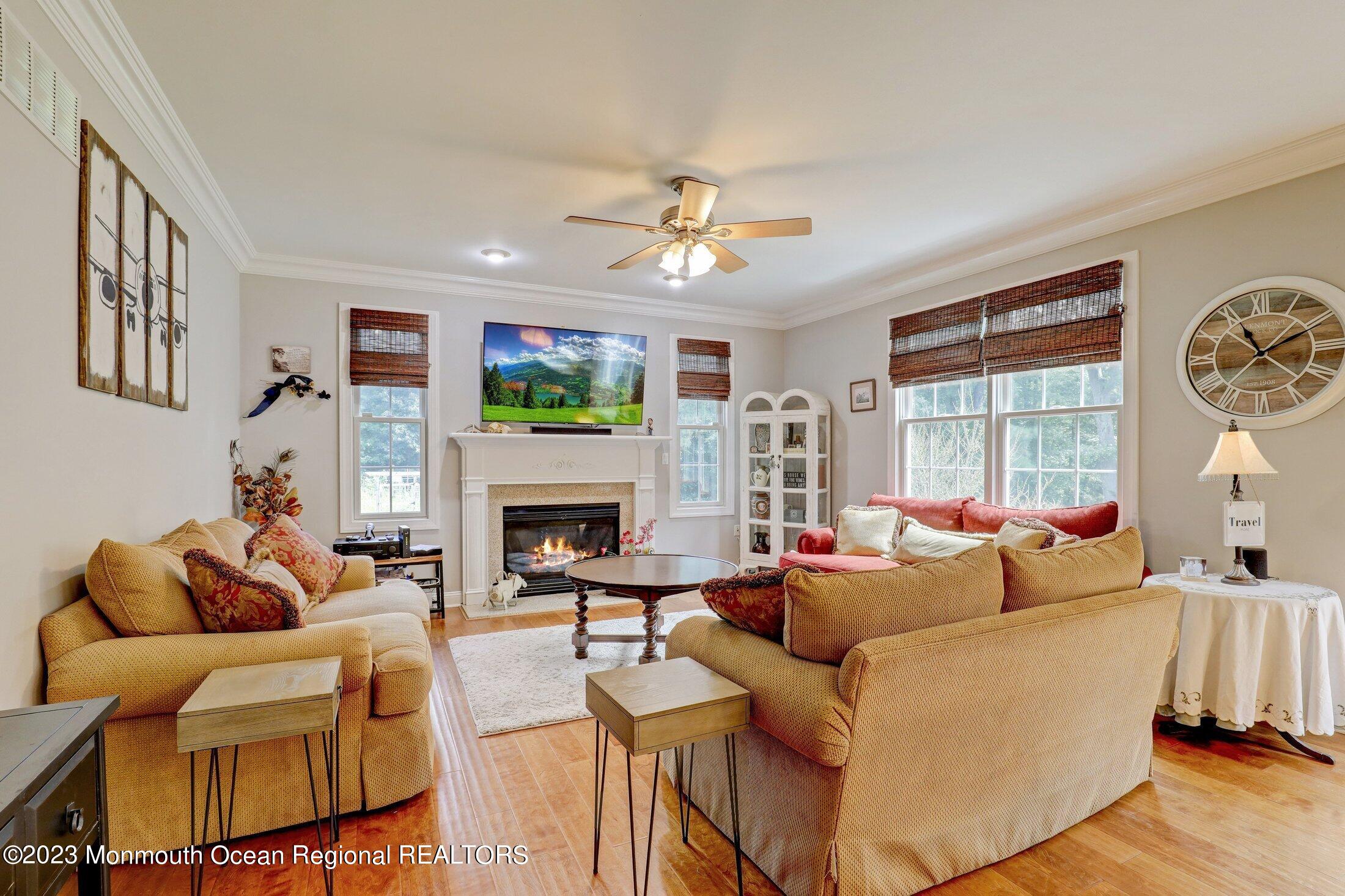352 Lanes Pond Road Howell, NJ 07731 - Photo 20 of 67 a living room with furniture a fireplace and a large window