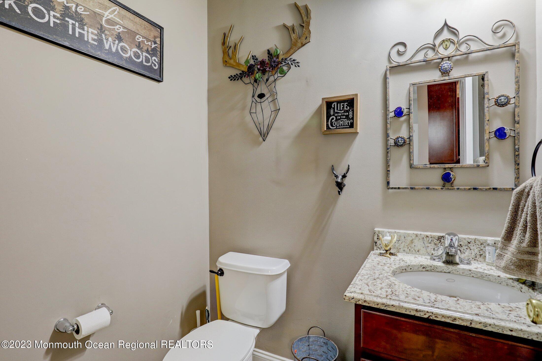 352 Lanes Pond Road Howell, NJ 07731 - Photo 23 of 67 a bathroom with a granite countertop sink mirror vanity and toilet