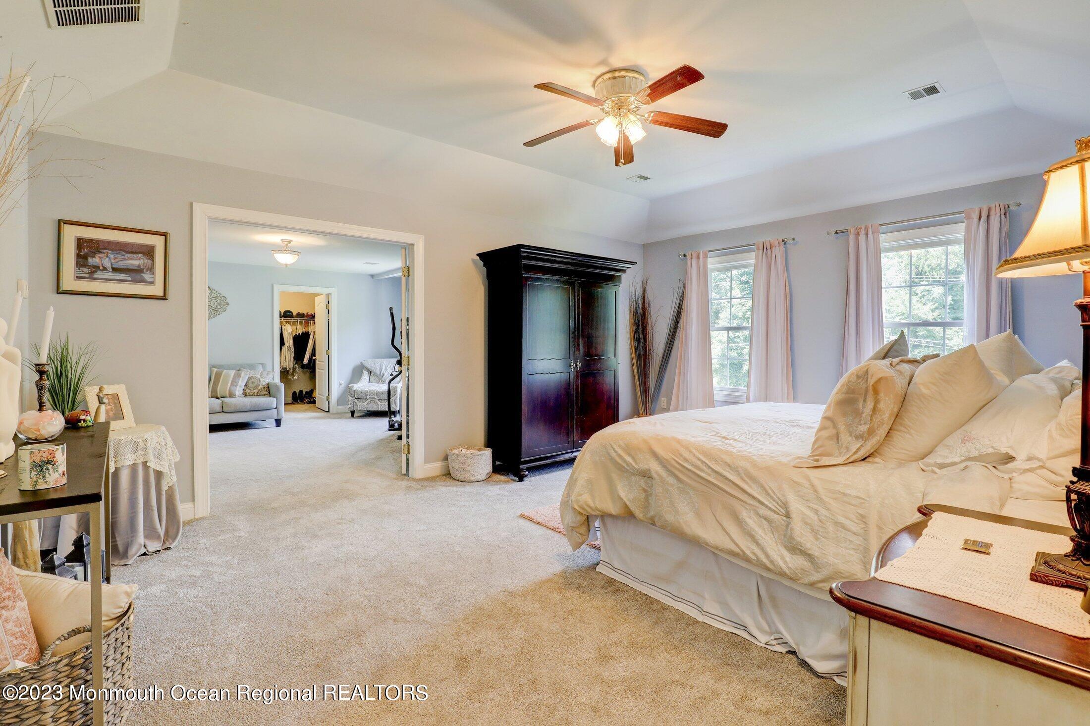 352 Lanes Pond Road Howell, NJ 07731 - Photo 27 of 67 a bedroom with a bed and a chandelier