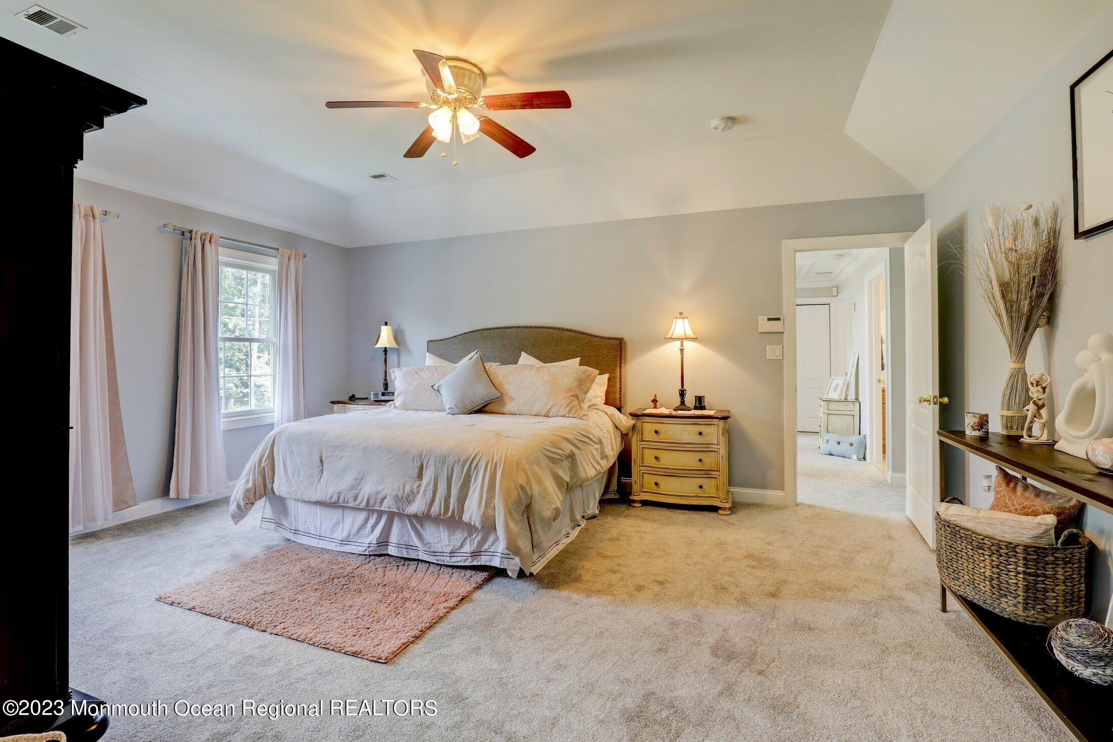 352 Lanes Pond Road Howell, NJ 07731 - Photo 28 of 67 a bedroom with a bed and a chandelier