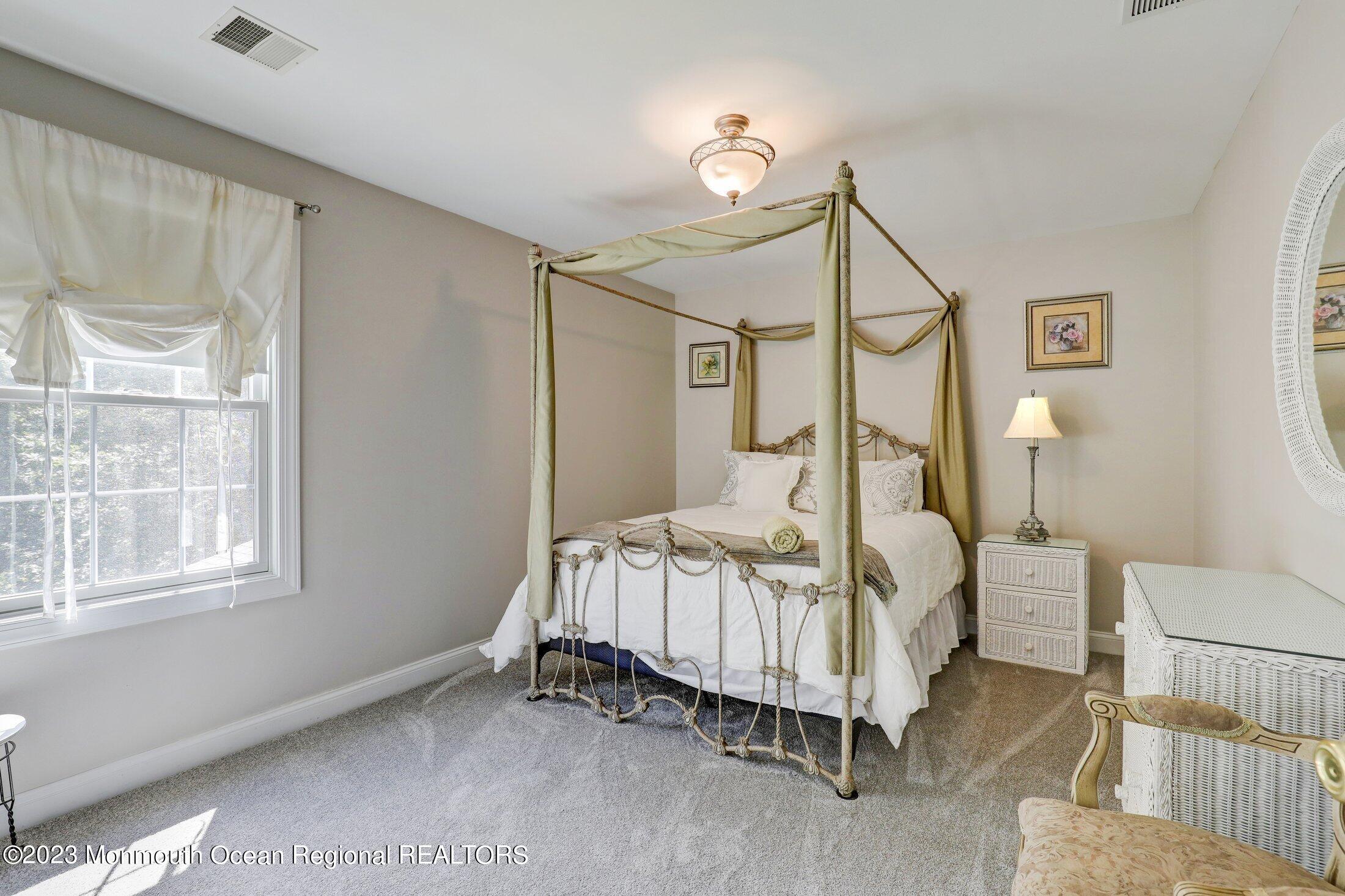 352 Lanes Pond Road Howell, NJ 07731 - Photo 33 of 67 a bedroom with a bed mirror and window